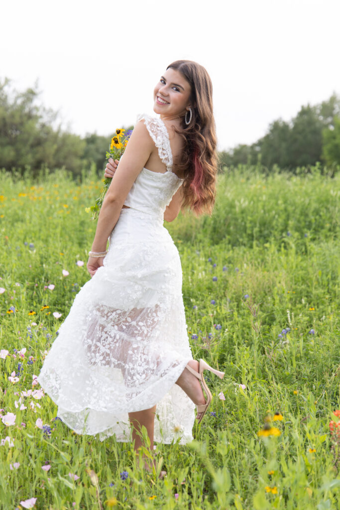 teen posing wildflowers